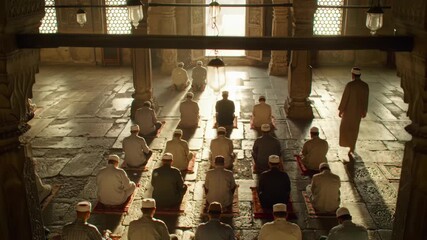 Muslim men praying in a mosque, a spiritual and religious gathering.