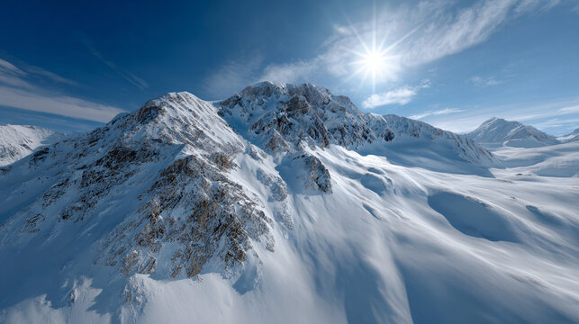 Snow-covered mountain peaks against a bright blue sky.