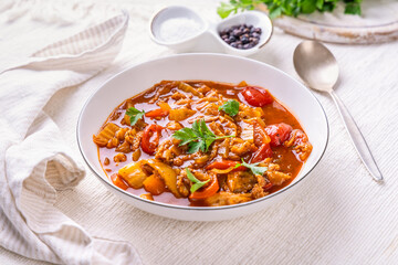 Spicy tripe soup made of beef with cabbage, red peppers and tomatoes