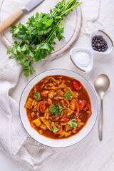 Spicy tripe soup made of beef with cabbage, red peppers and tomatoes