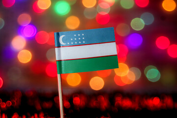 Uzbekistan flag against a beautiful, glowing rainbow bokeh background. Ideal for Independence Day, Silk Road tourism, Central Asia trade, and Turkic culture content.