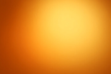 暖かい光に包まれたオレンジグラデーションの滑らかな背景