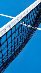 Close-up of a Table Tennis Net on a Blue Table.