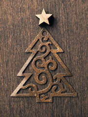 Rusty Christmas tree shape with wooden star shape on a rustic wooden background