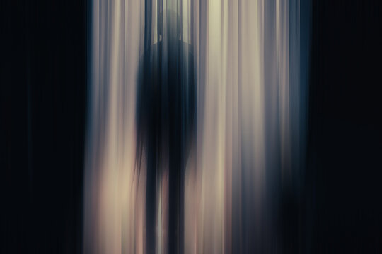 Dark Silhouette of a Person in Abstract Light Flow at Night
