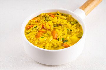 Tasty Italian Penicillin Soup, autumn winter immunity booster chicken vegetables orzo soup. Traditional european comfort food with ingredients for cooking on white table