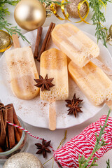 Christmas egg-nog ice-pops, ice cream popsicle with frozen eggnog cocktail. Alcohol or non-alcohol winter gelato dessert, with whipped creamy texture, copy space