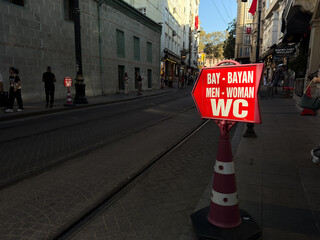 Street WC sign on Muradiye Cd in Fatih district directing pedestrians to public toilet