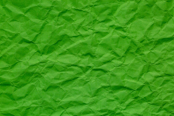 Macro crumpled green paper background,Close-up macro green crumpled paper background texture,Abstract light green paper texture as background. Texture of slightly crumpled craft paper.