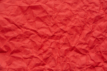 Macro crumpled red paper background,Bright red crumpled paper background,Red crumpled paper texture macro,Red crumpled paper as a texture or background. Bright red crumpled paper for backgrounds,