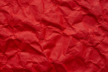 Macro crumpled red paper background,Bright red crumpled paper background,Red crumpled paper texture macro,Red crumpled paper as a texture or background. Bright red crumpled paper for backgrounds,