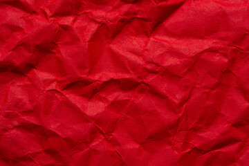 Macro crumpled red paper background,Bright red crumpled paper background,Red crumpled paper texture macro,Red crumpled paper as a texture or background. Bright red crumpled paper for backgrounds,