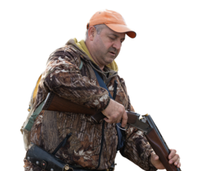 The hunter reloads his gun and prepares to shoot at game