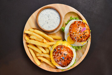 Fresh tasty 2 chicken burger with white sauce and french fries on plate