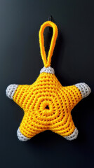Fototapeta premium Christmas star ornament handmade with yellow and gray yarn adds festive charm to holiday decor and brings joyful spirit to any Christmas
