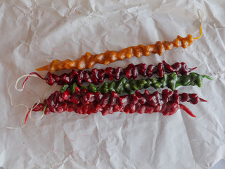 Colorful churchkhela candies on parchment paper, traditional Georgian sweets. These delicious, colorful churchkhela candies are a traditional Georgian dessert, perfect for a sweet treat or cultural ce