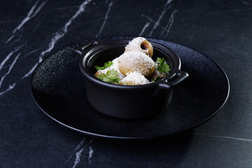 Gourmet Olive Appetizer In Black Ceramic Pot With Parsley Garnish