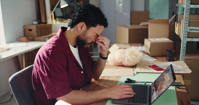 Frustrated, man or ecommerce in office with laptop for distribution backlog, logistics fail or headache. Computer, exhausted person or migraine for courier delay, supplier problem or reputation risk.