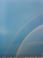rainbow over the sea, dark blue sky view