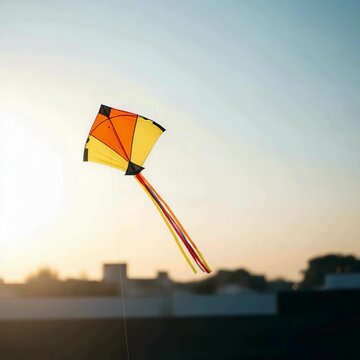 video of a vibrant kite soars gracefully against the clear blue sky, its colorful patterns creating a captivating spectacle of childhood joy and freedom