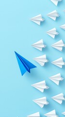 Fototapeta premium Blue Paper Airplane Leads a Group of White Paper Planes on a Bright Blue Background