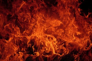 Fototapeta premium Vibrant Flames Dance in a Mesmerizing Display of Heat and Light During a Nighttime Bonfire
