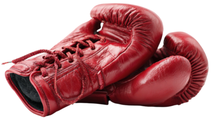 A pair of well-worn, glossy, vibrant red leather boxing gloves, laced, set against a black backdrop