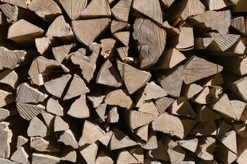 Stacked firewood logs. Chopped wood, a natural fuel for heating.  Woodpile texture, timber background.