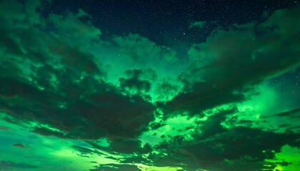Obraz premium Green, ethereal light bursts through the dark clouds under a night sky speckled with stars in this dreamy image