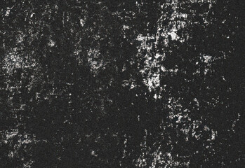 Close up of weathered black concrete surface with scattered white specks and distressed texture providing a gritty grunge background ideal for design printing and texture overlays