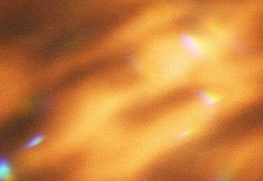 Abstract warm golden light texture with soft bokeh and blurred shapes, creating a rich ambient background suitable for technology, fashion, marketing, and creative design projects