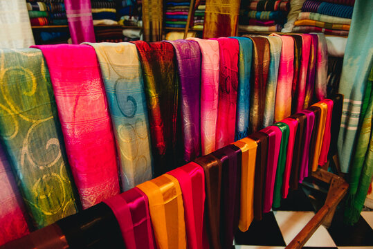 Close-up of assorted traditional patterned scarves hanging on a rack in a shop, Fez, Morocco