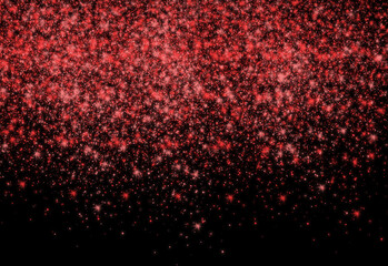 Close-up view of vivid red glitter particles cascading over a dark background, creating a festive, sparkling texture ideal for celebrations, design accents, and visual effects