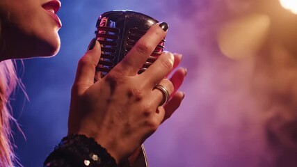 Close up of a glamorous woman singing into a retro microphone during a live performance on stage, with dramatic lighting and smoke creating an atmospheric and intimate jazz club vibe