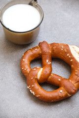 Delicious traditional Bavarian Brezeln or pretzels with a brown salty crust. German Pretzel Brezel with cup of milk. Food on Oktoberfest