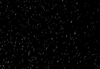 Abstract night scene with a deep black background scattered by countless tiny white specks resembling stars or snowflakes, creating a serene celestial atmosphere