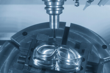 The 5-axis machining center cutting mold parts with solid barrel end mill tool in the light blue...