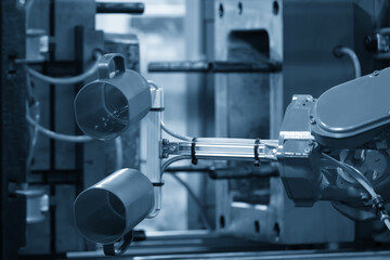 Close up scene material handling process the plastic drinking glass by robotic system.