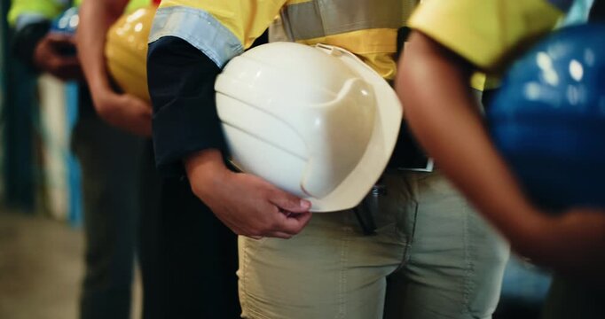 Hands, row and people with helmet in factory safety, site inspection and industry protocol. Line, employees and waiting with hard hat for quality control, workplace compliance and maintenance ppe