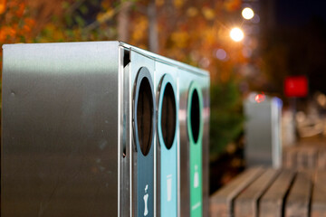 Modern glossy metal trash can. Waste sorting. Green concept.