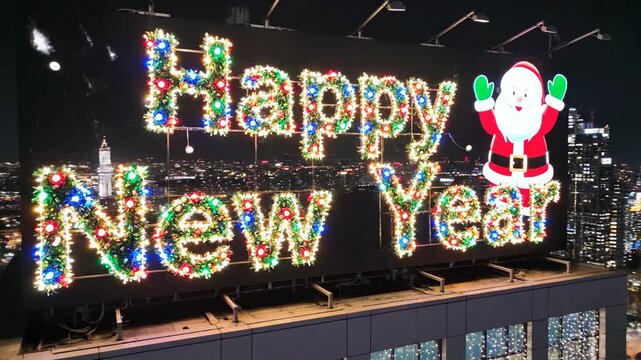 rooftop billboard glowing happy new year, colorful illuminated sign with cartoon santa, fireworks and sparkling led lights over city skyline at night, festive urban celebration on skyscraper edge.