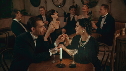 Elegant couple in vintage style sharing a romantic moment in warm candlelight. Concept of luxury lifestyle campaigns, holiday promo, beauty-fashion assets, and cinematic social storytelling.