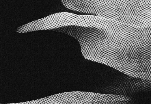 Abstract black and white textured composition with flowing curves, grainy texture, and high contrast shadows, featuring soft edges for modern design and versatile backgrounds