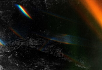 Abstract cosmic scene featuring a dark, textured surface with colorful light refractions, subtle grain, and nebula-like glow across a moody, mysterious night landscape