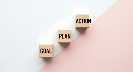 Wooden blocks display goal plan and action on a pink white surface