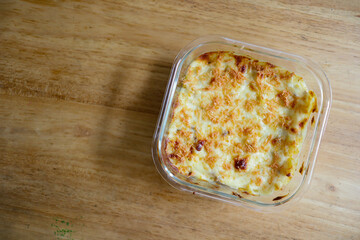 Delicious baked pasta dish in a clear glass container.