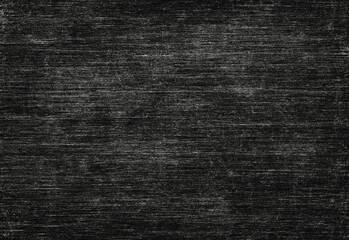 Close up of a textured dark background featuring subtle horizontal grain and charcoal tones, ideal for backdrops, design projects, product photography backgrounds, and layouts
