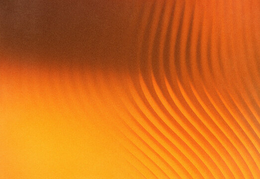 Macro close up of warm orange abstract texture with a smooth gradient and flowing curved lines, creating a dynamic background ideal for design, advertising and art projects