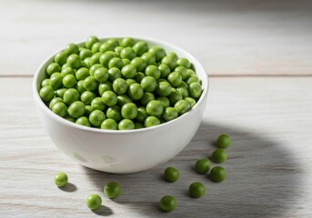Fresh green peas in a white bowl on a wooden table