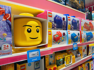 Naklejka premium Dnipro, Ukraine 11.13.2025: Various LEGO brand building sets and boxed kits displayed on shelves in a toy store. Highlights the popular construction toy brand and retail presence